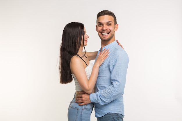 Relationship and love concept - Portrait of happy couple on white surface