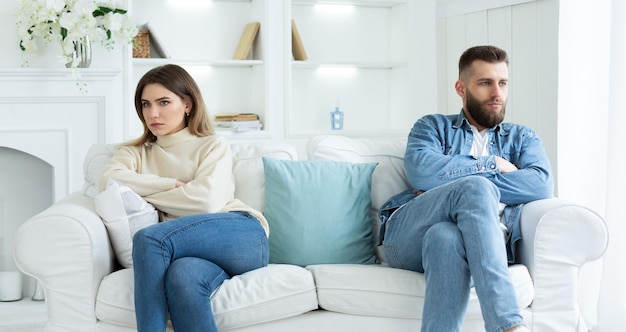 Relationship Problems Couple Sitting On Different Sides Of Couch