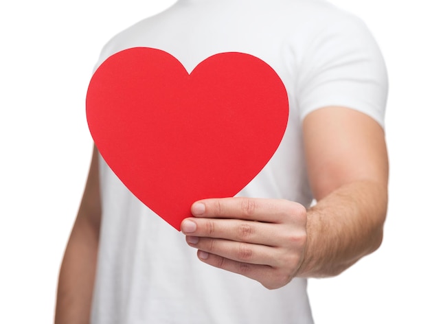 relationships and love concept - closeup of man hands with heart