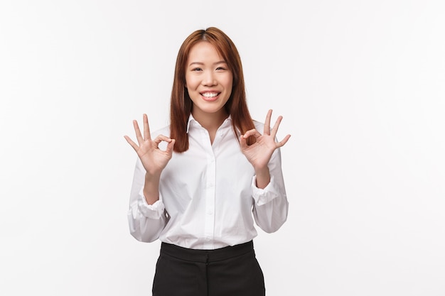 Relax, everything okay. Cheerful and carefree asian woman say no problem, make ok gesture and smiling, assure everything done, deal signed, guarantee great service and quality, 