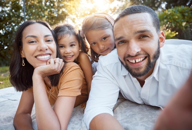 Relax happy and selfie with family on picnic for summer support or bonding in park Smile freedom and affectionate with portrait of parents and children in grass in countryside for joy and nature