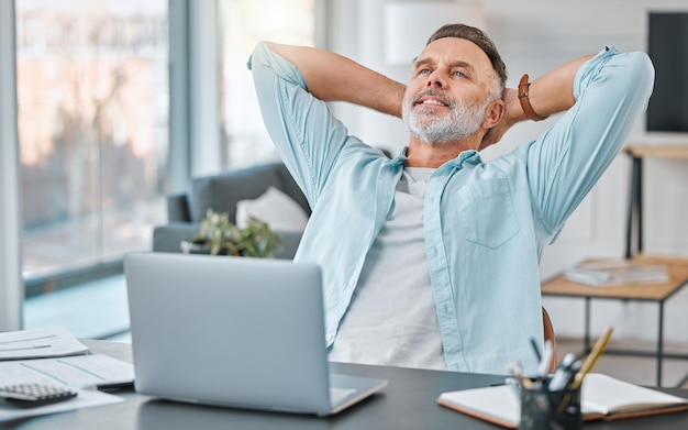 Relax laptop and mature man stretching in living room for satisfaction savings or budget Finance computer and happy person at table for investment monthly expenses or retirement fund in home