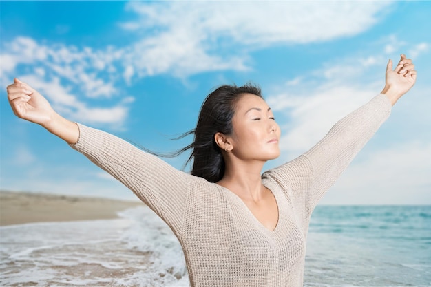 Relaxed happy young woman on beach