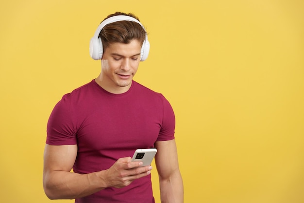 Relaxed man listening to music with the mobile and headphones