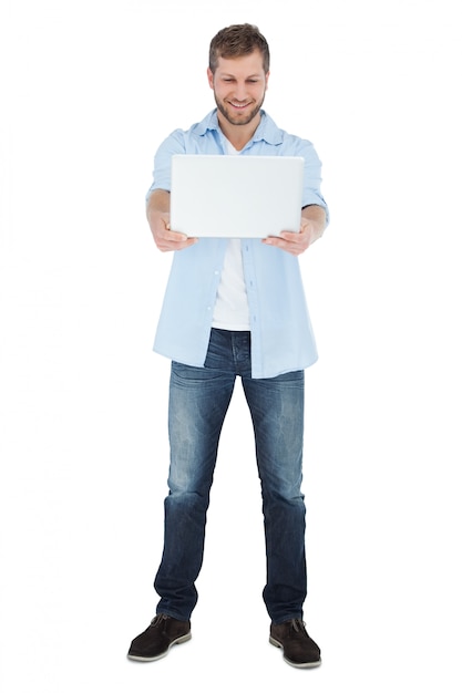 Relaxed model looking at his laptop