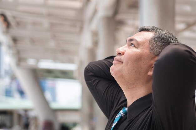 Relaxed old man thinking or planning with idea portrait of carefree relaxed asian man thinking planning looking up finding a good idea south east or southeast asian 50s old senior man model