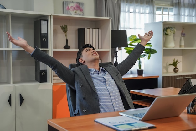 Relaxed person businessman portrait smiling In Chair After Online Work in office work using l