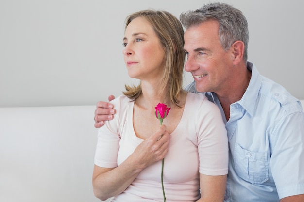 Relaxed romantic couple with a flower at home