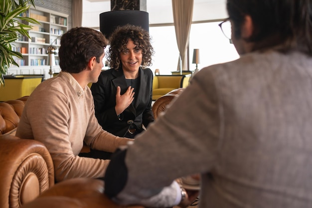 Relaxed scene of a businesswoman talking with her colleagues in a cafeteria