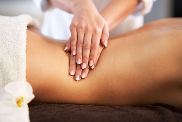 Relaxed smiling woman receiving a back massage in a spa