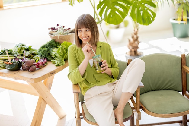 Relaxed woman with healthy food in the room with plants