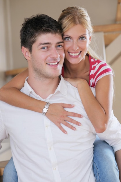 Relaxed young  couple watching tv at home in bright living room