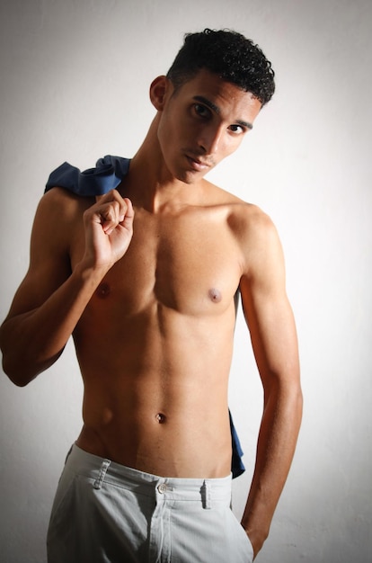 Relaxed young latin man wearing blue shirt Medium body isolat