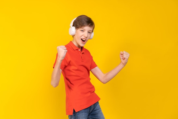 Relaxed young man in casual red shirt posing isolated on yellow background