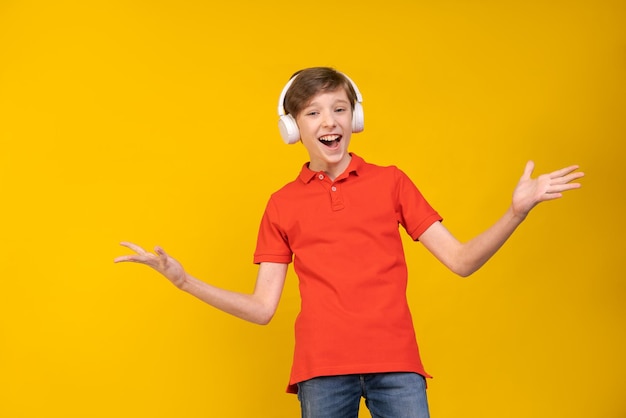 Relaxed young man in casual red shirt posing isolated on yellow background