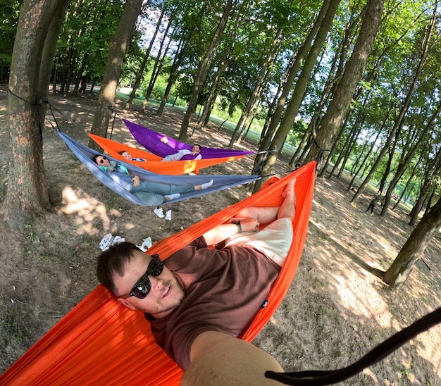 Photo relaxing in colorful hammocks in the forest