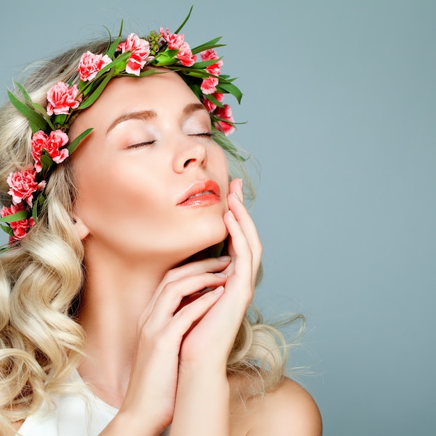 Relaxing Spa Model Blonde Woman with Healty Clean Skin and Flowers. Antiaging and Cosmetology