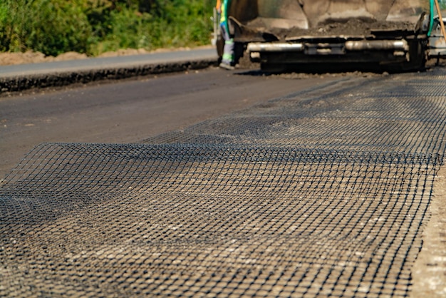 reliable technology of paving roads with reinforced mesh. Close-up