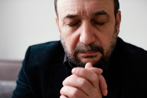 Religious man praying peacefully