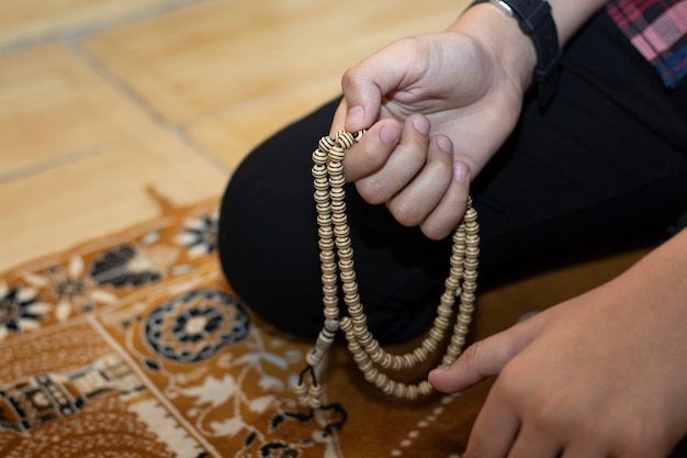 Religious muslim boy praying inside the mosque muslim boy praying with beats