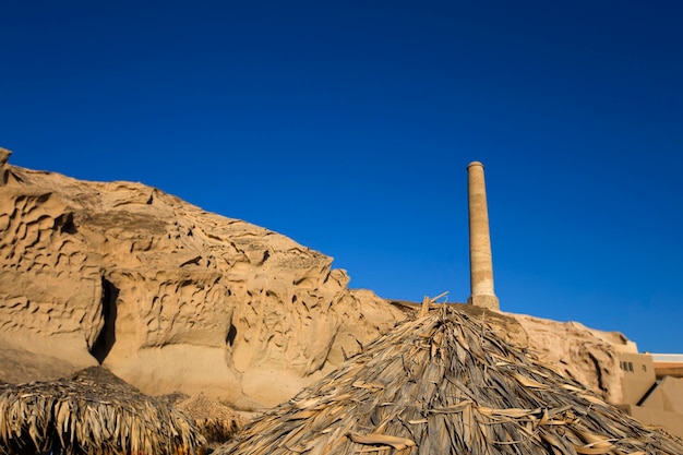 Remains of the old tomato processing factory on Vlychada beach at Santorini island in Greece