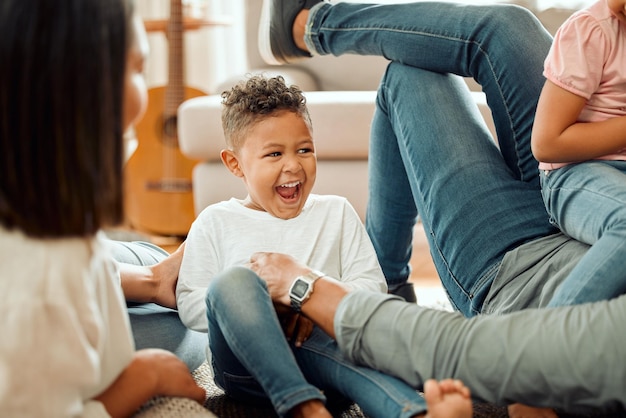 Remember always our room of giggles Cropped shot of a young family playing together on the lounge floor at home