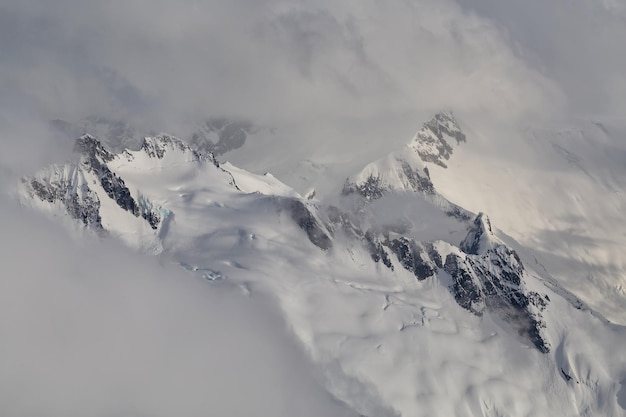 Remote mountain peak covered in snow in British Columbia Aerial Background