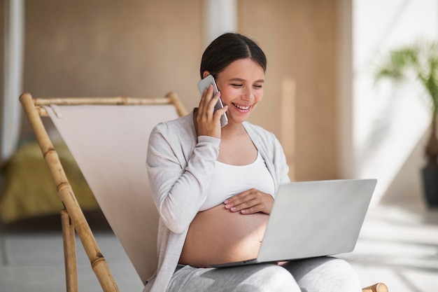 Remote Work Concept Happy Pregnant Lady Using Laptop And Talking On Cellphone