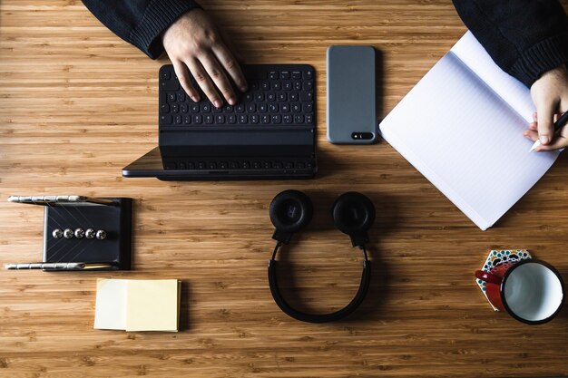 Remote work kit on wooden office desk