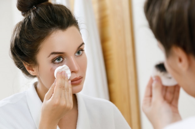 Removing makeup with a cotton pad