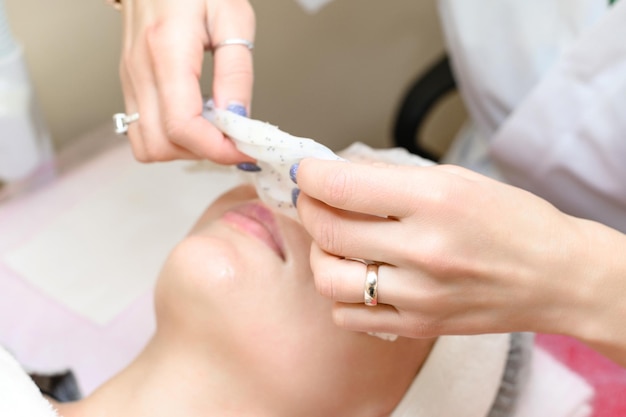 Removing a moisturizing mask from the face in a cosmetology office