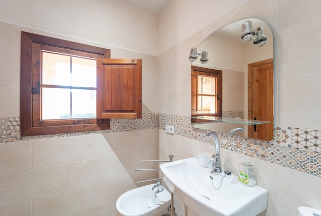 Renovated kitchen area with two arched windows and white walls