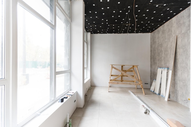 Renovated room with shopping window - empty store shop with wooden floor and white walls