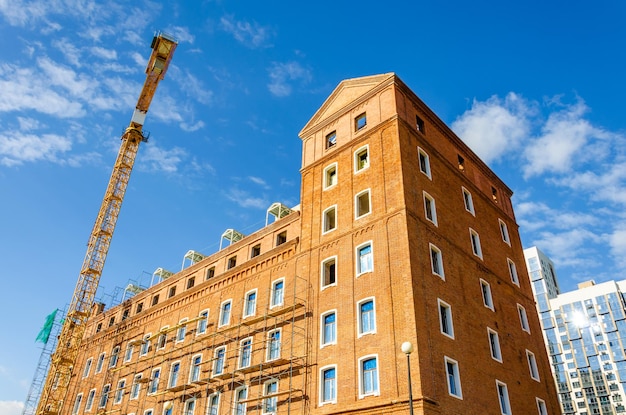 Renovation of an old brick building.Renovation. Crane and scaffolding.