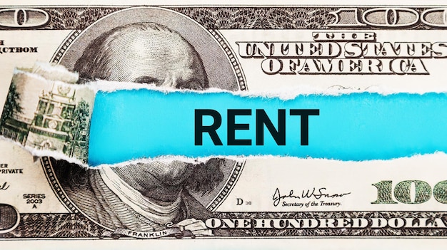 Rent word written on with American Dollarbills The word rent on dollar usa backgroundThe concept of renting housing and real estate The cost of a rented home or apartment Saving money Rental