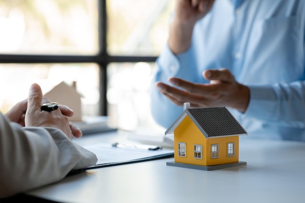 Rental company employee is discussing the details before the customer agrees to sign a rental contract explaining the details and the terms and conditions of the rental Real estate rental ideas