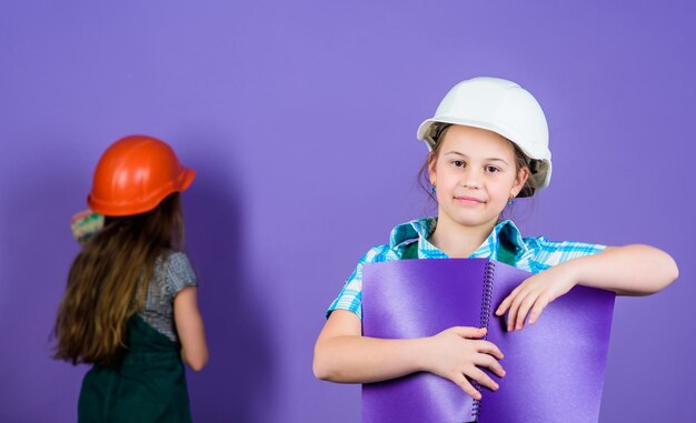 Repaint walls. Home improvement activity. Kids girls planning renovation. Violet is my favorite color. Children sisters renovation their room. Control renovation process. Kids happy renovating home.