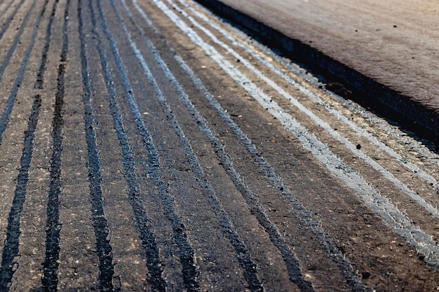 Repair of asphalt pavement of the road New asphalt on the road Hot bitumen when laying new asphalt