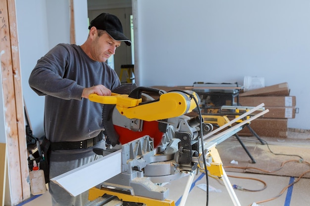 Repair building construction work saw circular saw boards sticks flinders sawdust gloves hands peopl