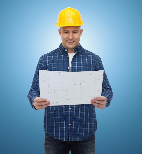 repair, construction, building, people and maintenance concept - smiling male builder or manual worker in helmet with blueprint over blue background