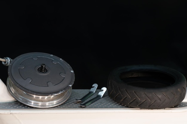 Repair of an electric scooter in the workshop Replacement of the tire and the front wheel chamber Camera and electric motor closeup