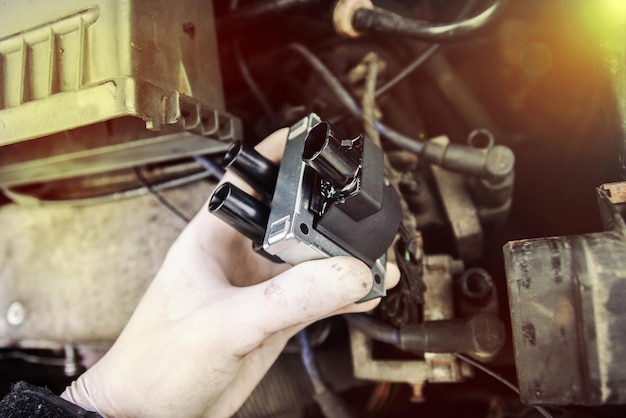 repair electricians ignition coils in a car, high-voltage wires.