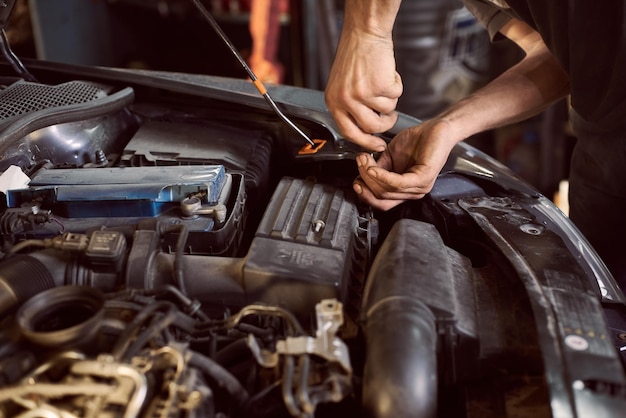 Repair man fixing car in repair station