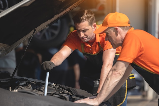 Repair Man Worker Polishing Automobile Car Body In Garage