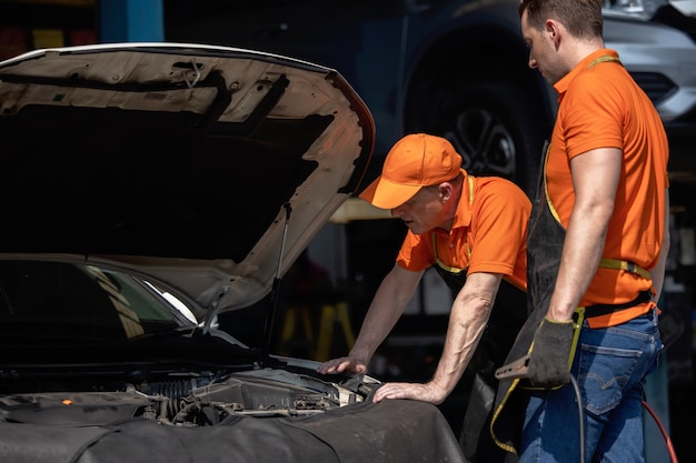 Repair Man Worker Polishing Automobile Car Body In Garage