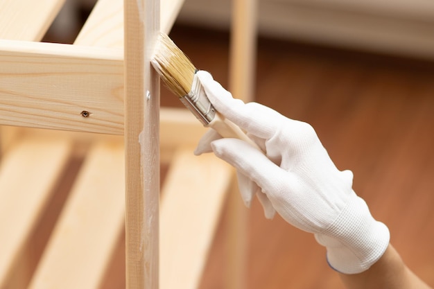 Repair painting restoration of furniture Women's hand with a brush and paints