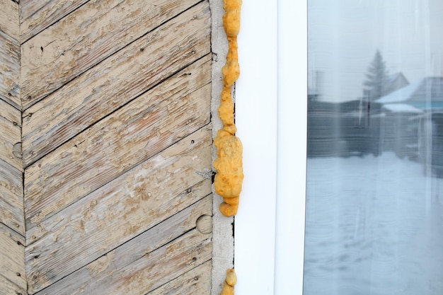 Repair of windows in an old, dilapidated wooden house.