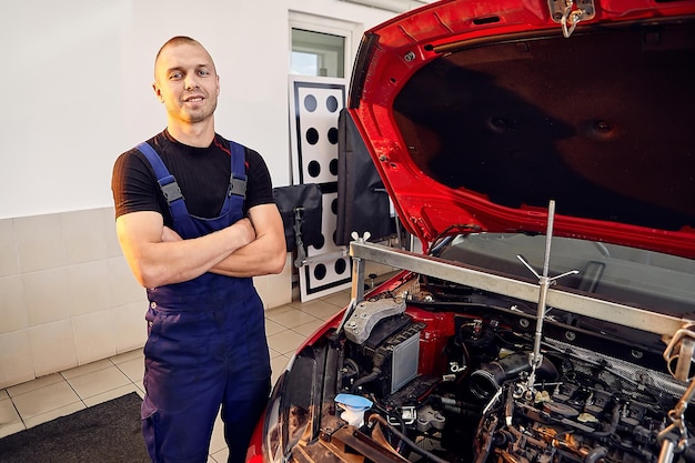 Repairing a car engine in autoservice center Auto mechanic working in the garage