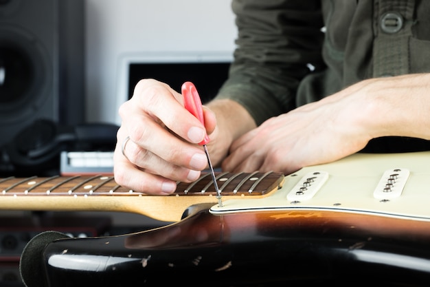 Photo repairing old electric guitar