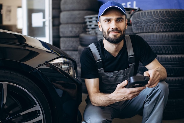 Repairman checking pressure sensors with a special tool